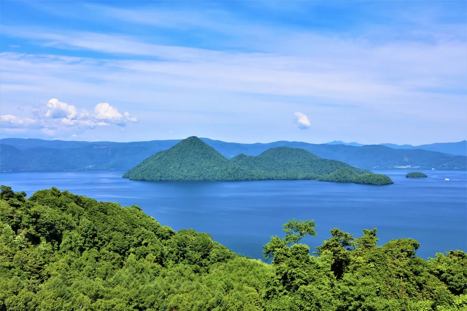 Blue water and forested islands at Lake Toya