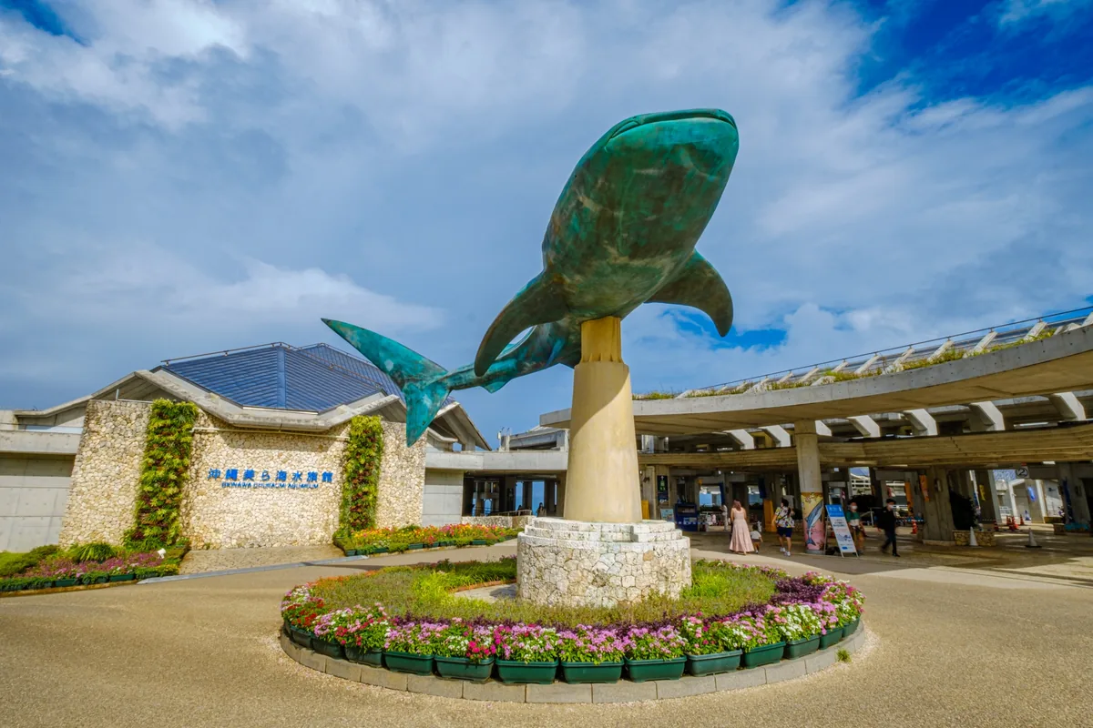Whale shark sculpture and the Okinawa Churaumi Aquarium entrance sign