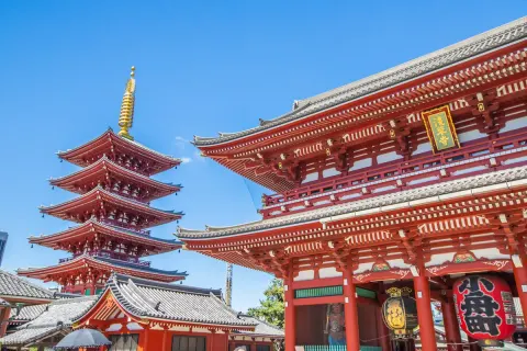 The Hozomon gate and five-story pagoda of Senso-ji temple against a blue sky in Asakusa