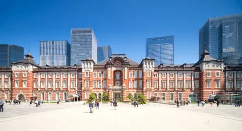 The restored red-brick Marunouchi facade of Tokyo Station below the district's skyscrapers