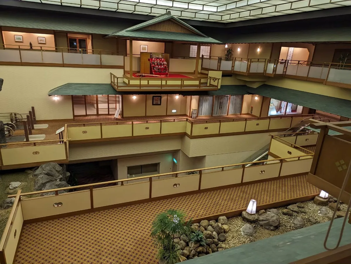 An atrium with balconies, Japanese-style woodwork and a rock garden below