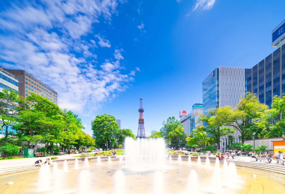 A fountain in Odori Park with Sapporo TV Tower in the background