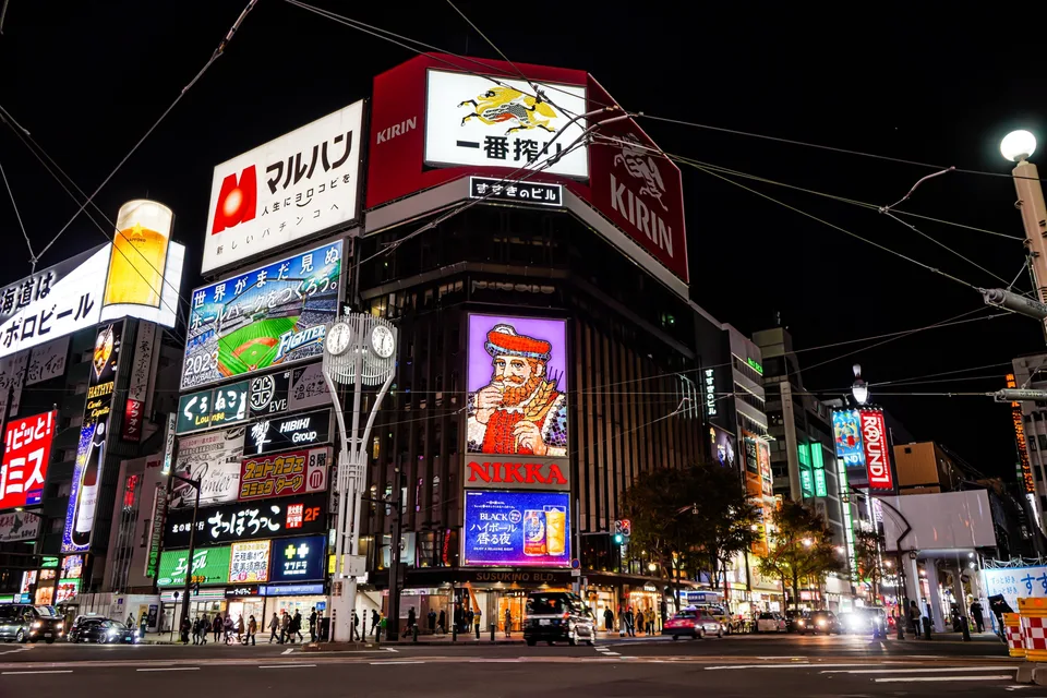 Illuminated signs and buildings around a Susukino intersection