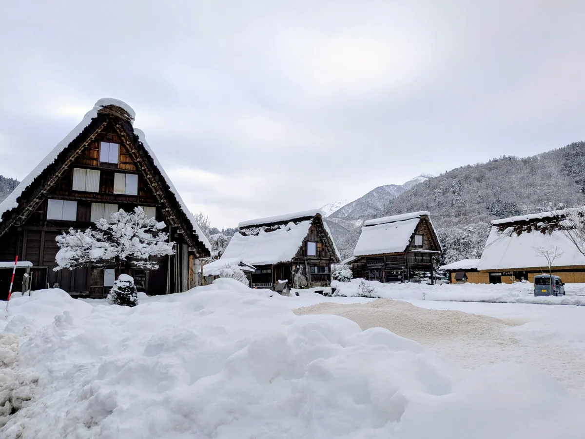 Thatched houses and a snow-covered lane in winter in Shirakawa-go