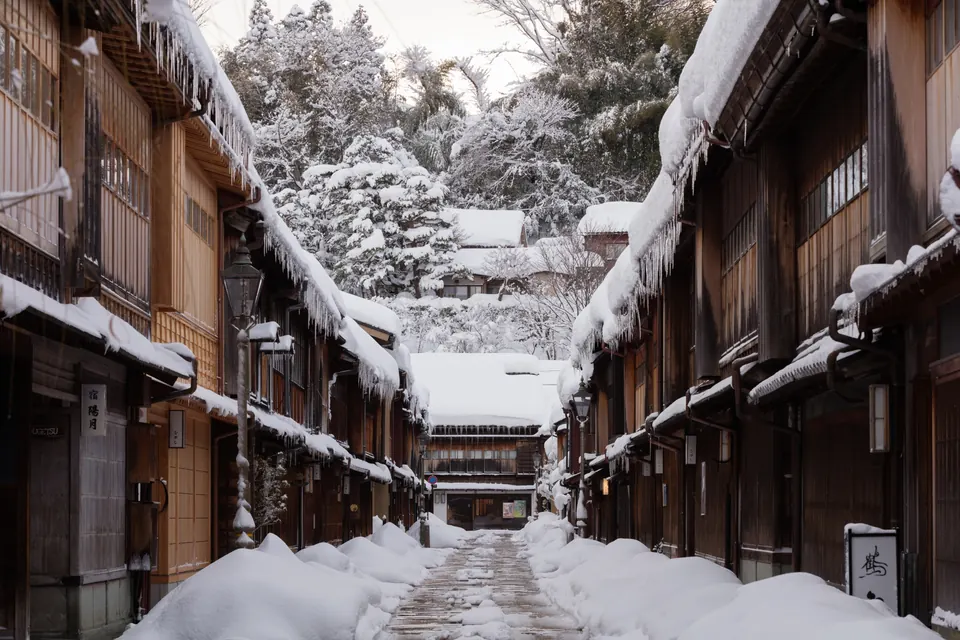 Snow and icicles lining the wooden buildings along a street in Higashi Chaya, Kanazawa